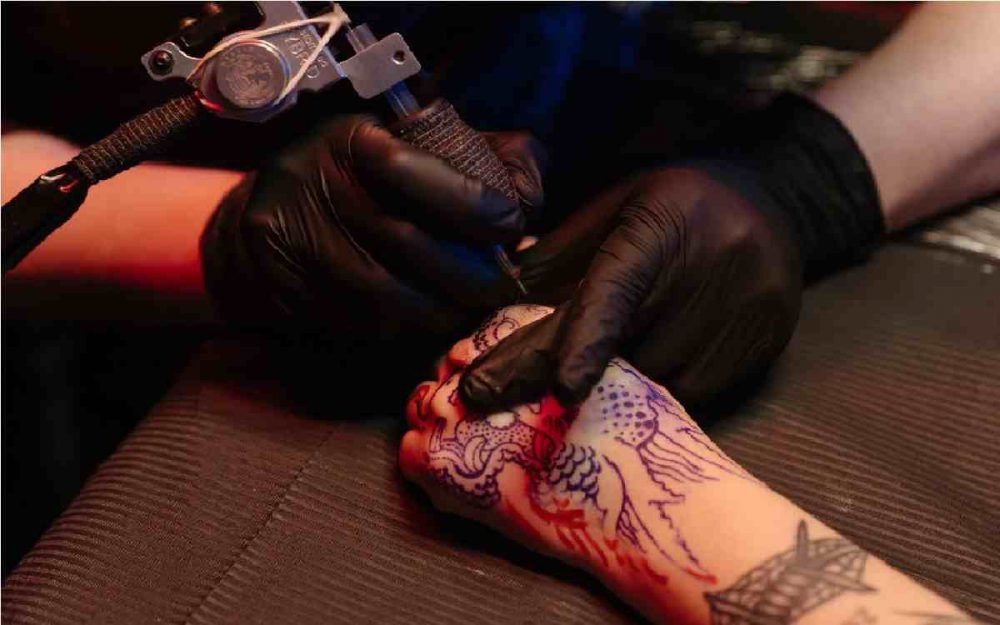 tatuador realizando un diseño